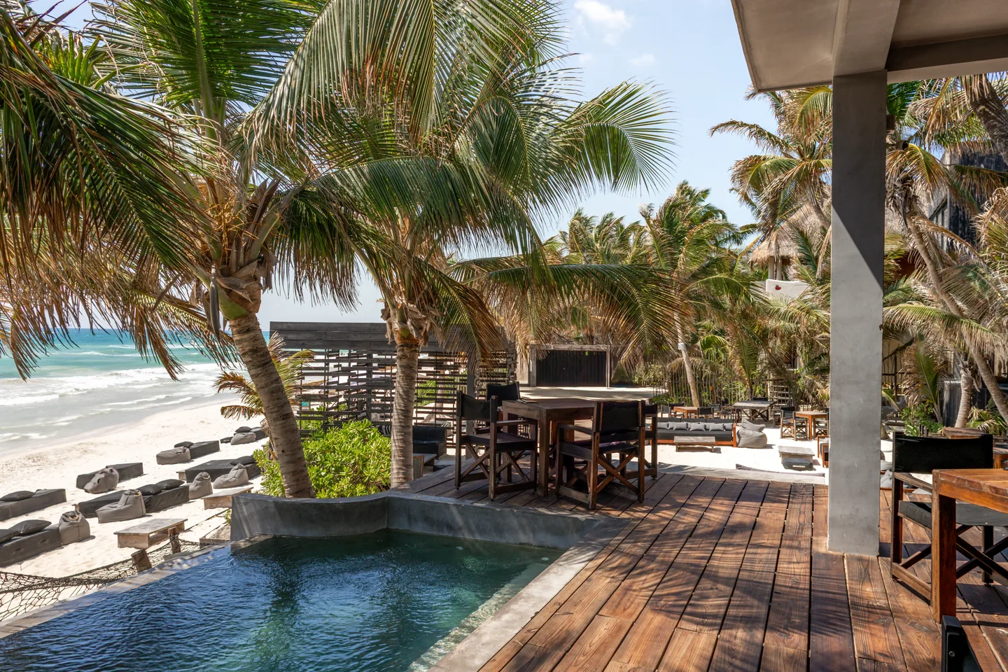 Outdoor patio with a small pool and beach view.
