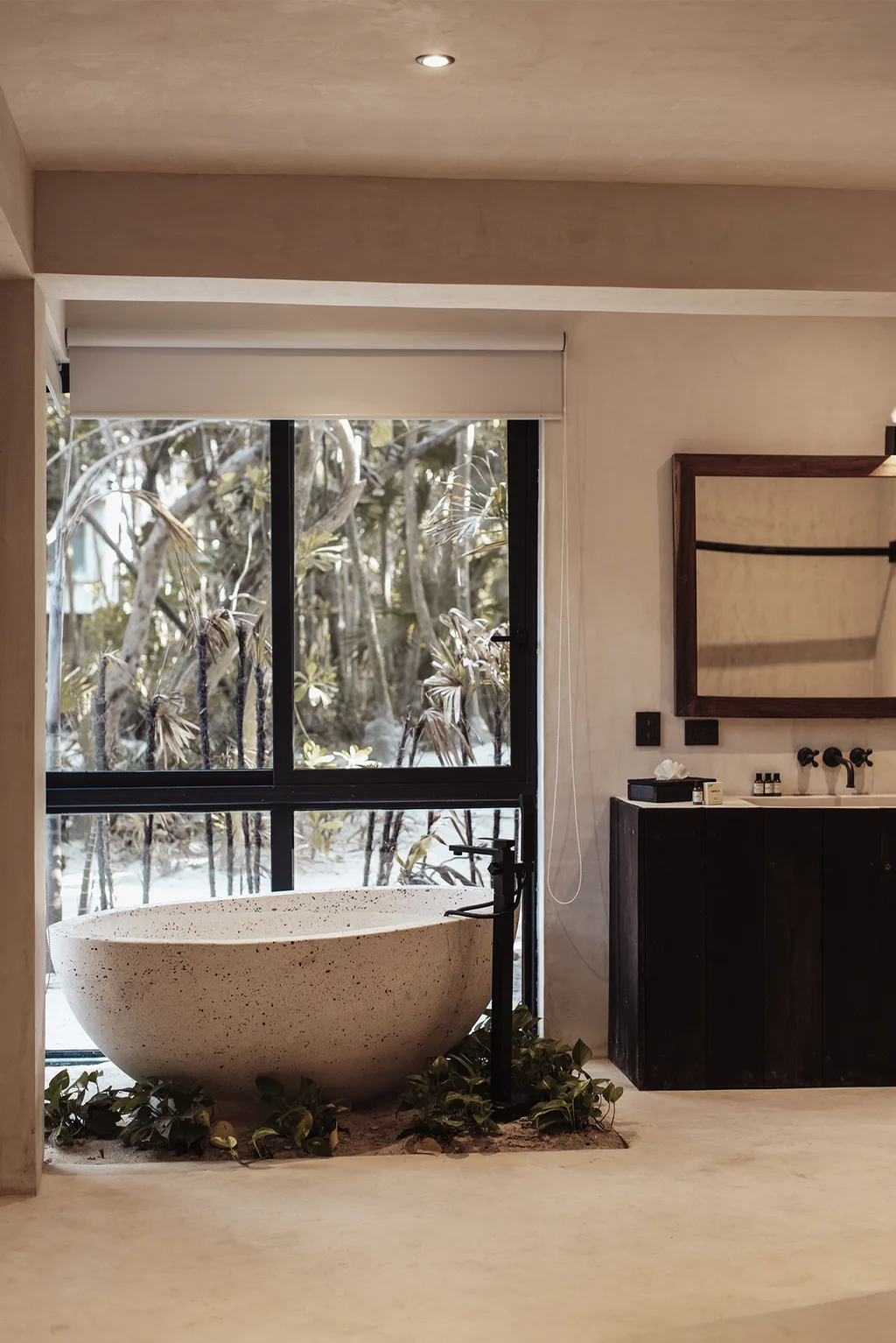 Bathroom with a large bathtub and a view of trees outside.