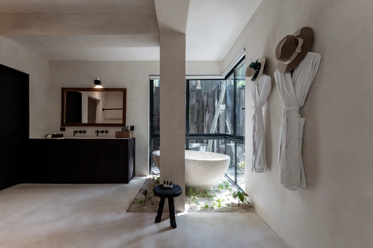 Bathroom with white walls, a bathtub, and a mirror.