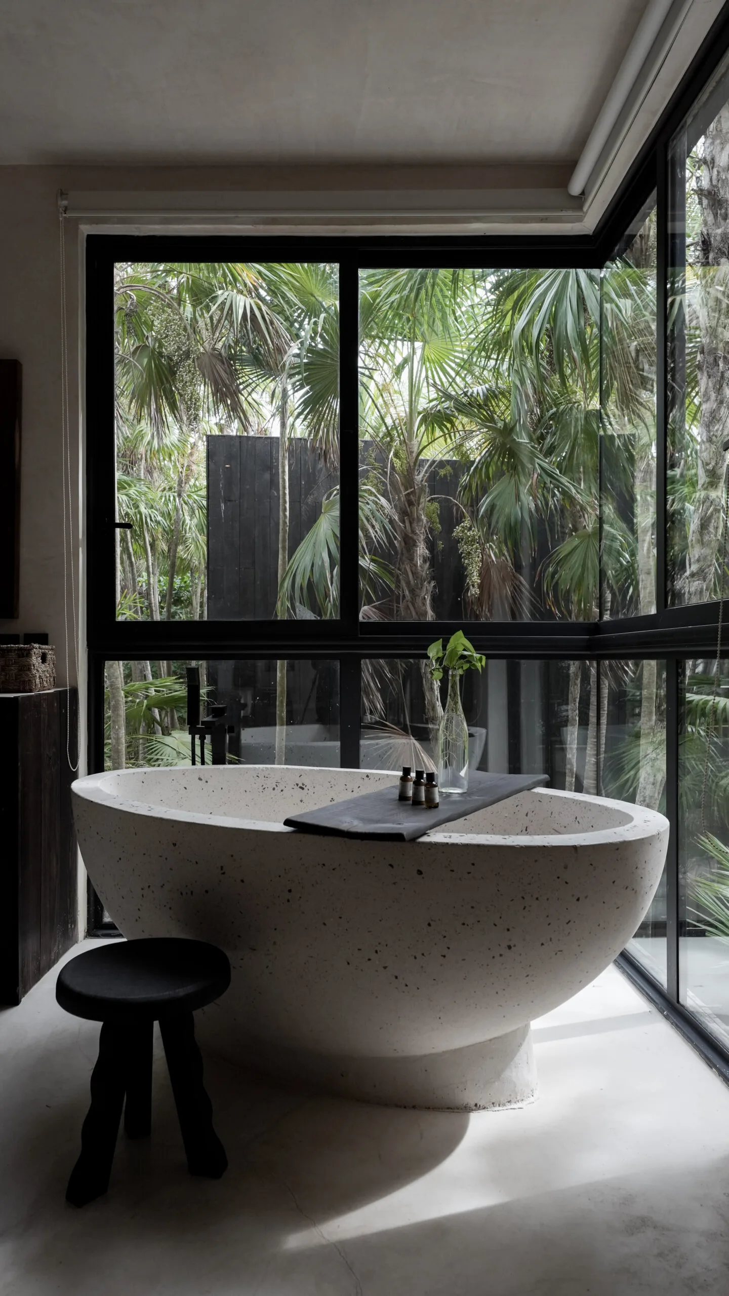 A large bathtub in a bathroom with large windows.