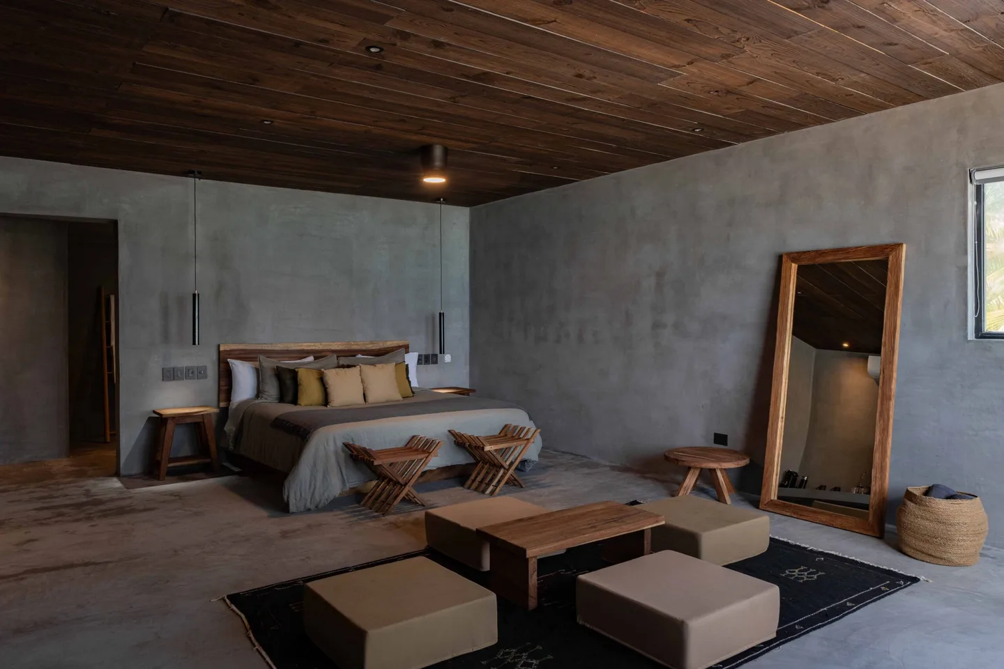 A bedroom with a wooden ceiling and gray walls.