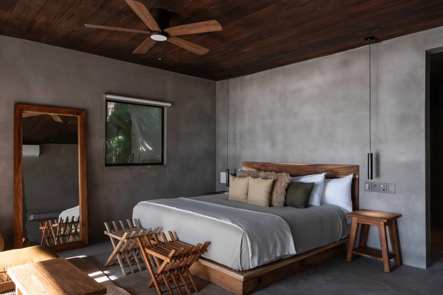 A bedroom with a wooden bed, wooden furniture, and a wooden ceiling.