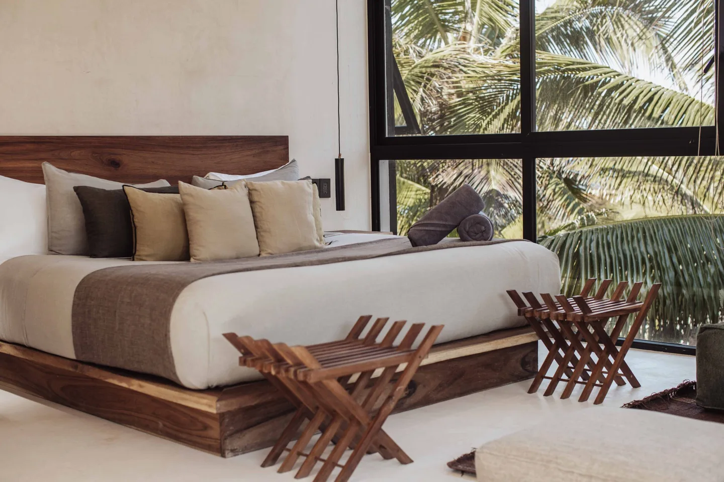 A bedroom with a large bed and wooden furniture.